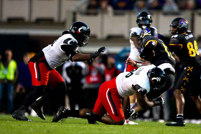 Cincinnati Bearcats defensive lineman Jabari Taylor (90) sacks East Carolina Pirates safety Dru Dotter (12) on third down in the first half of the NCAA football game between the Cincinnati Bearcats and the East Carolina Pirates at Dowdy-Ficklen Stadium in Greenville, NC, on Friday, Nov. 26, 2021. Cincinnati Bearcats At East Carolina Pirates 17